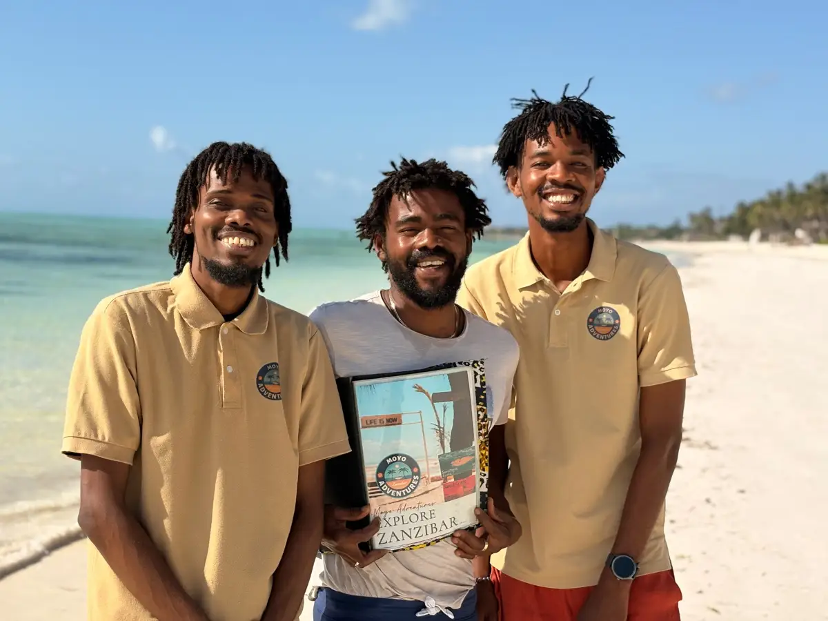 moyo adventures team posing for photo on the beach